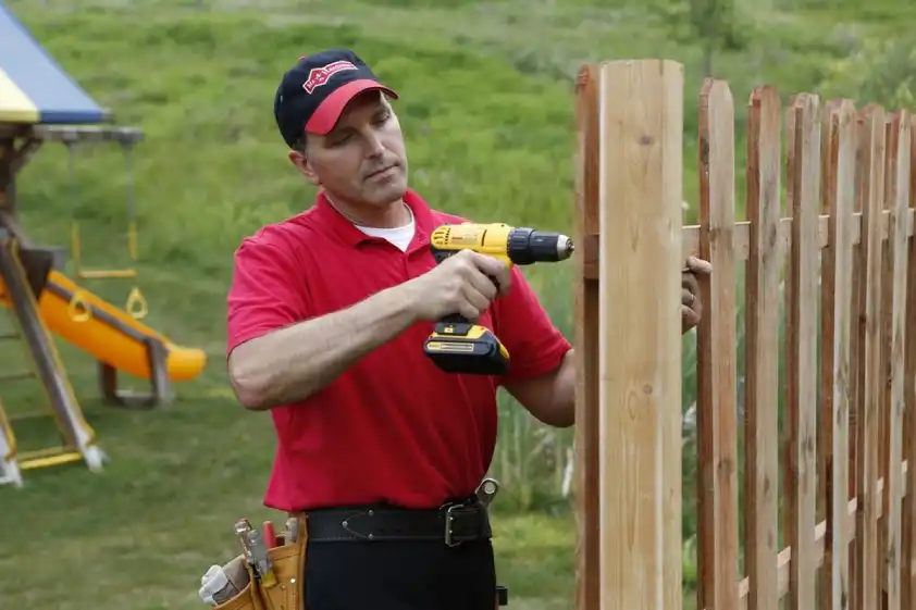 Mr. Handyman technician repairing fence on Charleston property