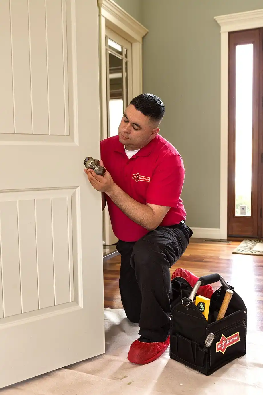 A technician from Mr. Handyman completing interior door repairs in Charleston, SC.