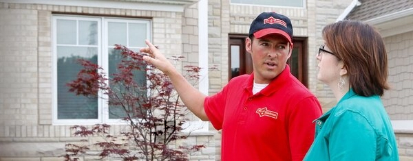 Mr. Handyman technician exploring siding repair service options with homeowner in Flower Mound.