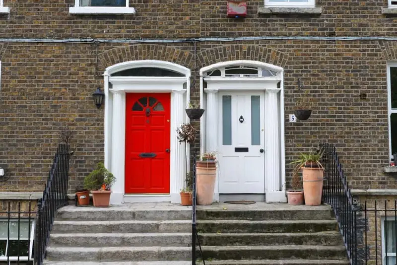 A red and white door on the exterior of homes that have received professional services for door repair in Northern Virginia.