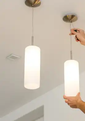 Handyman installing light fixture