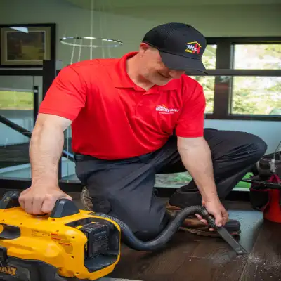 Mr Handyman cleaning the floor