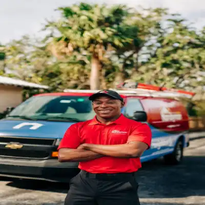 A smiling Handyman in front of a van.