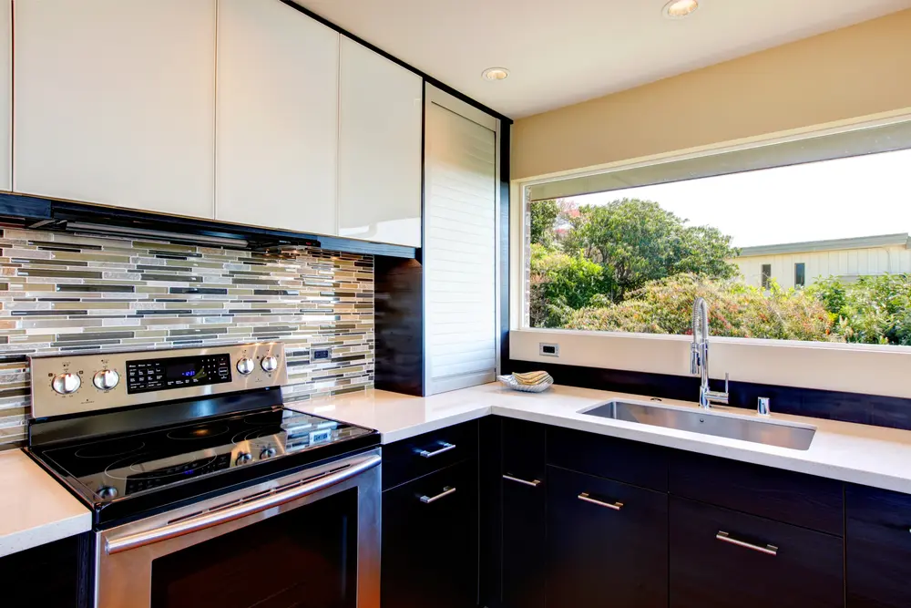 Kitchen stove with tile backsplash.