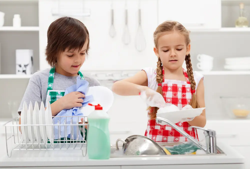 Boy and girl washing dishes.