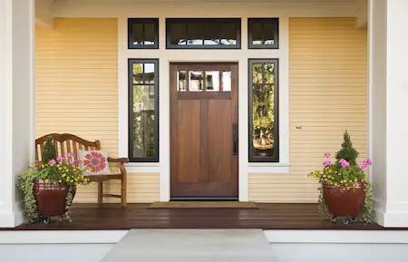 brown front door on yellow house