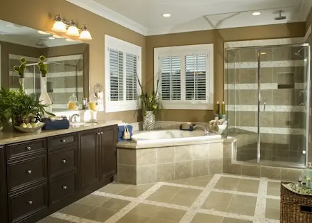 tiled bathroom with corner tub and shower stall