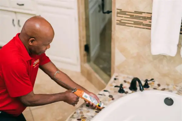 Mr. Handyman fixing cracked tile.