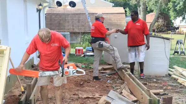 Mr. Handyman technicians repairing veteran's deck.