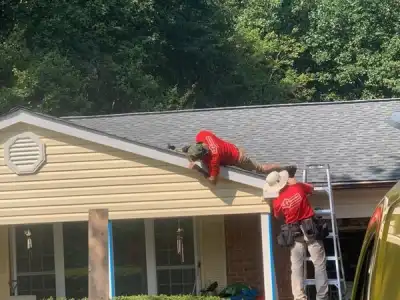 Two Mr. Handyman technicians working on soffit repair project for National Day of Service.