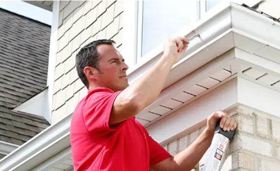 Mr. Handyman technician fixing gutter.