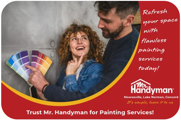 Happy couple choosing a color for one of their home’s walls.