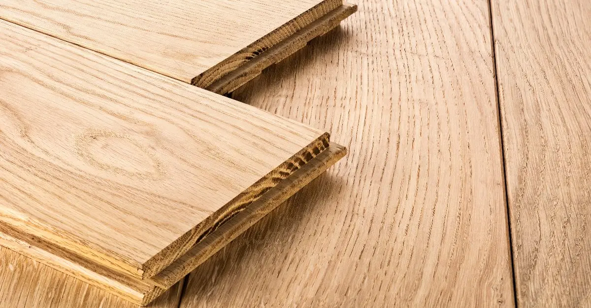 Parquet flooring boards sitting on a wood floor before being used for flooring repair in Walpole, MA.