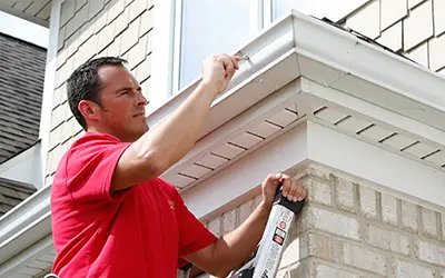 A My Handyman technician fixing a gutter.