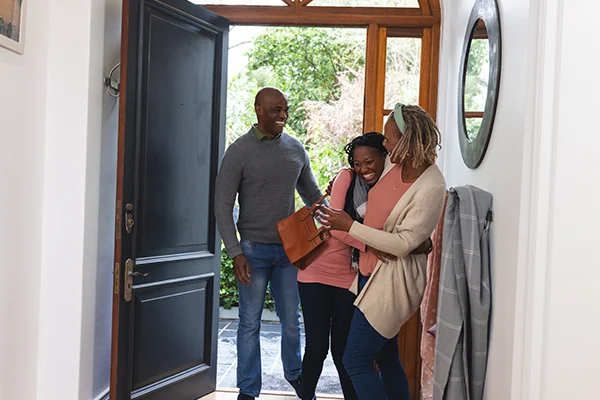 Happy parents welcoming daughter to their home.