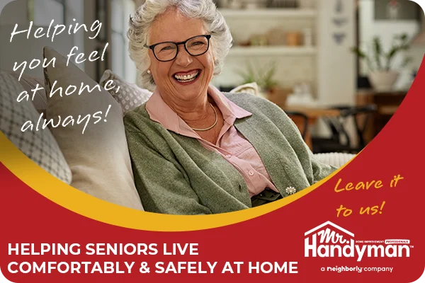Smiling senior woman sitting on a couch, feeling safe at home.