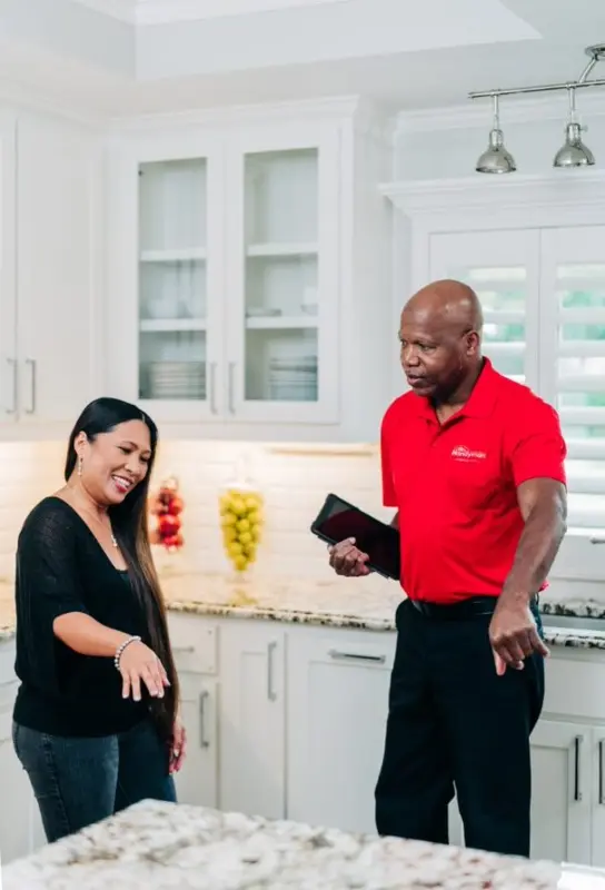 A My Handyman technician discussing sink installation and repair with a customer.