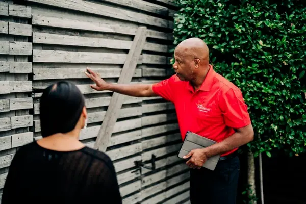 My Handyman going over exterior pressure washing services with woman.