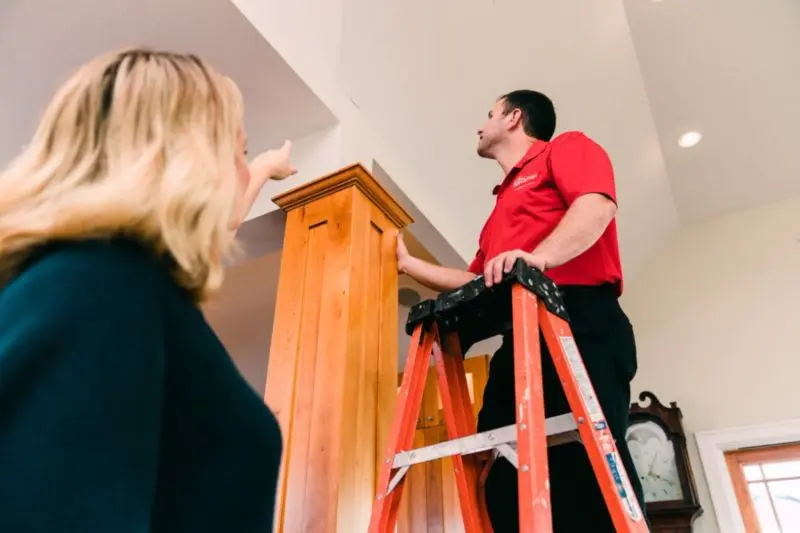 Mr. Handyman discussing ceiling repair with customer