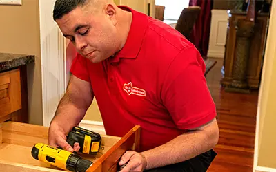 A My Handyman technician repairing a drawer.